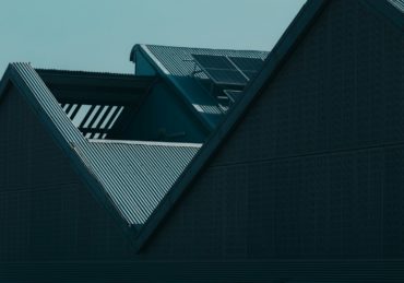 the roof of a building with a clock on it