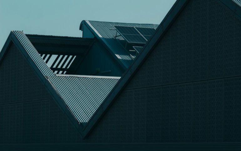 the roof of a building with a clock on it